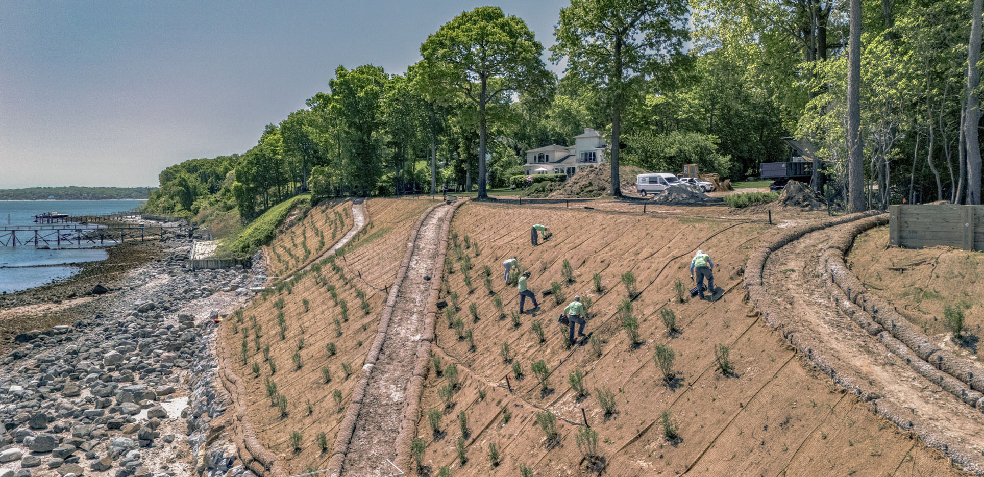 home in the hamptons with waterfront dock and sloping landscaping